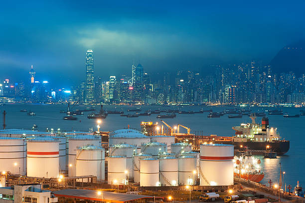 Oil tank in harbor Oil tank in Victoria harbor of Hong Kong city at night gas tanker ship stock pictures, royalty-free photos & images