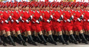Women in Beijing's civilian militia wear red mini-skirts and carry submachine guns as they march past Chinese President Jiang Zemin during the...