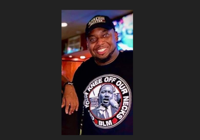 A person smiling at the camera Description automatically generated