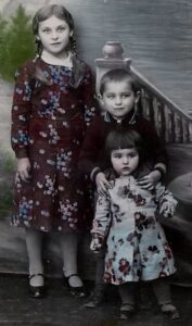 Eva with her older brother and sister.