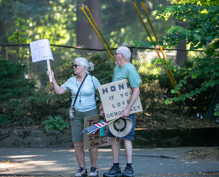 A person and person holding signs AI-generated content may be incorrect.