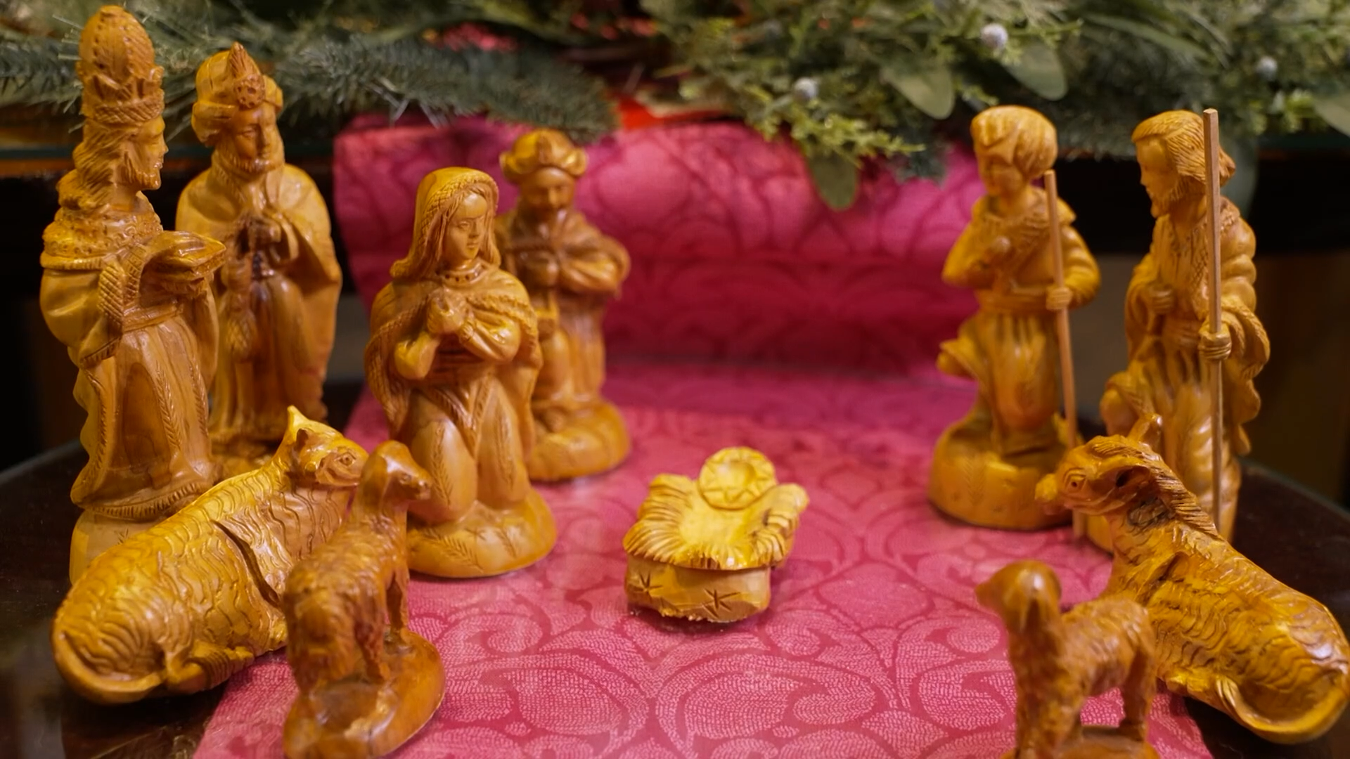A group of small statues on a pink surface AI-generated content may be incorrect.